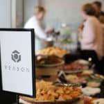 nice shot of reason logo with catering and food and drinks being served