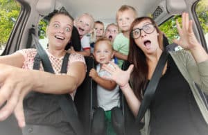 Crazy family taking a selfie in the car. Vintage filtered look