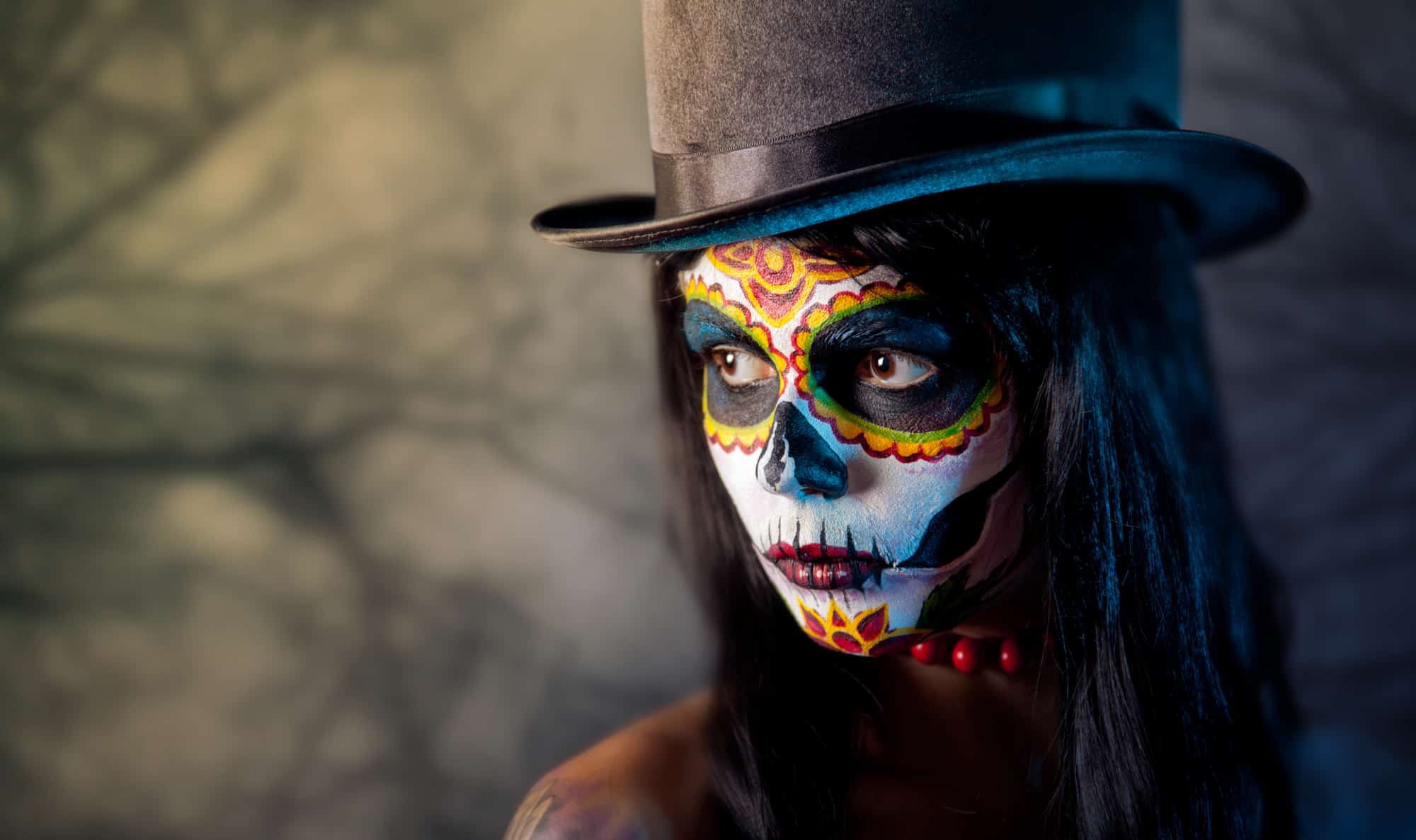 Sugar skull girl in tophat, in the forest