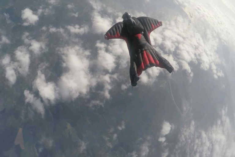 men skydiving in a wing suit