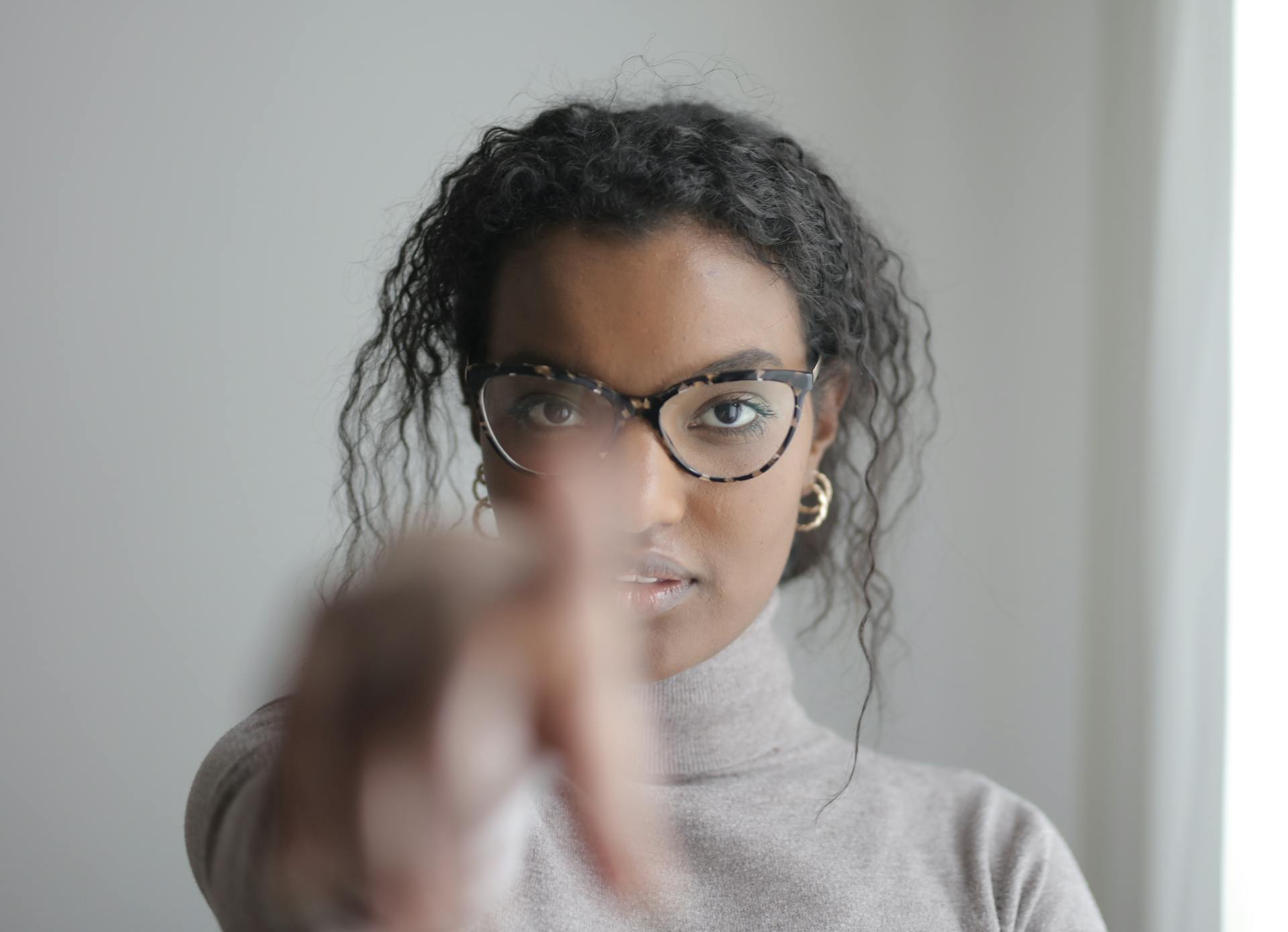 Woman points at camera