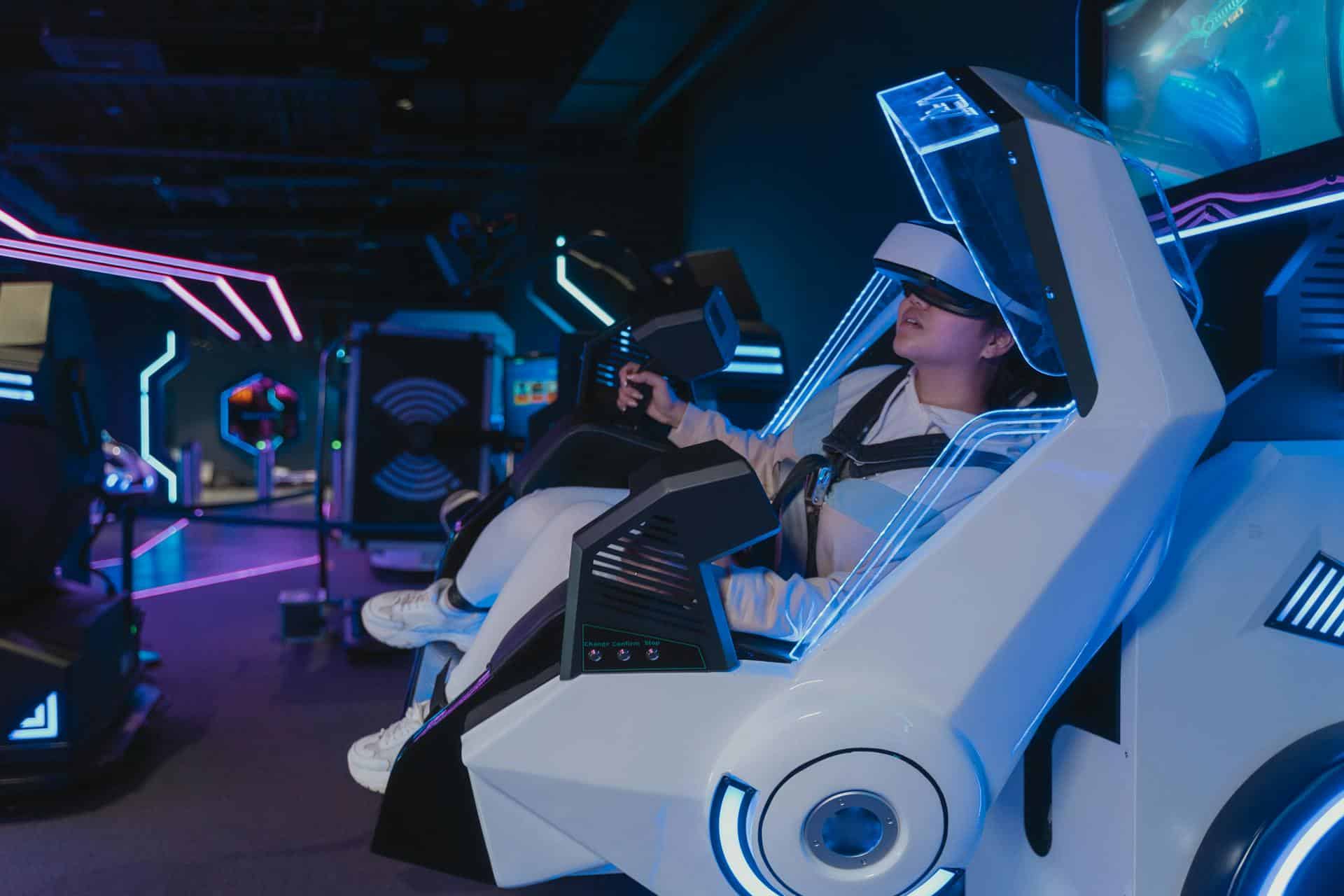 Girl immersed in futuristic VR chair leans to the left is response to something she see in the game.
