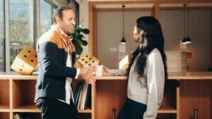 Man and woman talking while leaning on a counter top