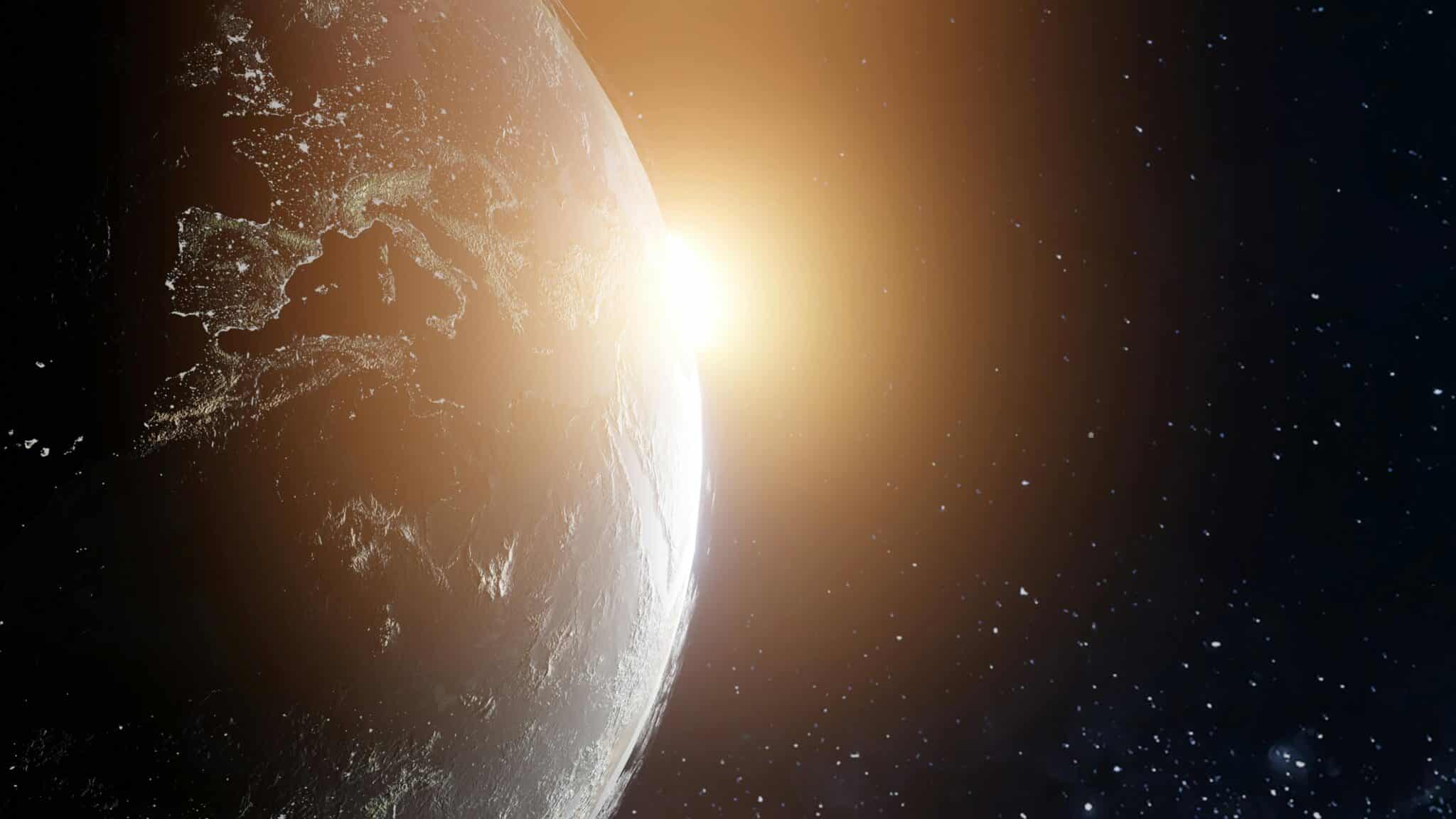 Earth with the sun behind it