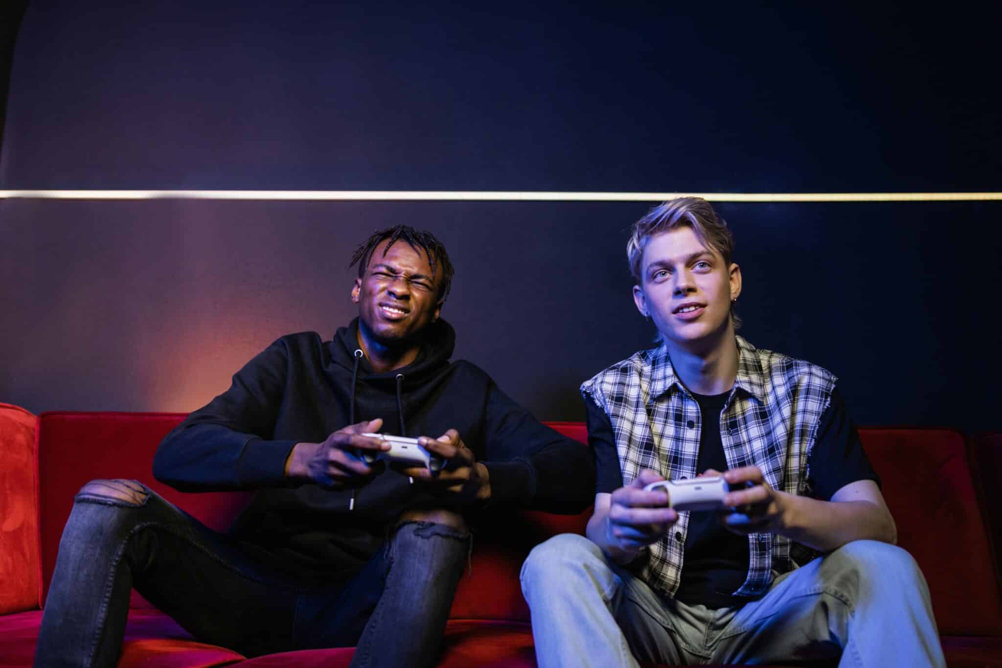 Two men playing video games on the couch