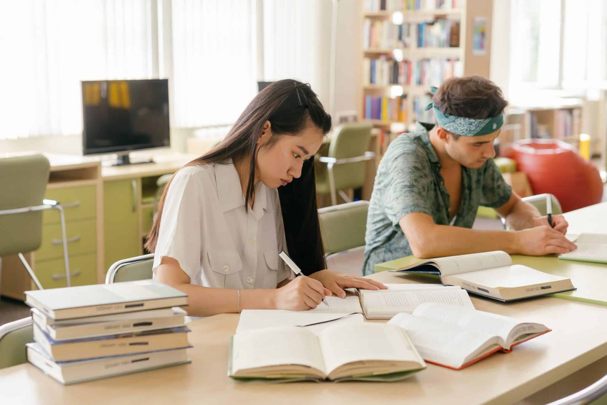 Two college students studying at a desk