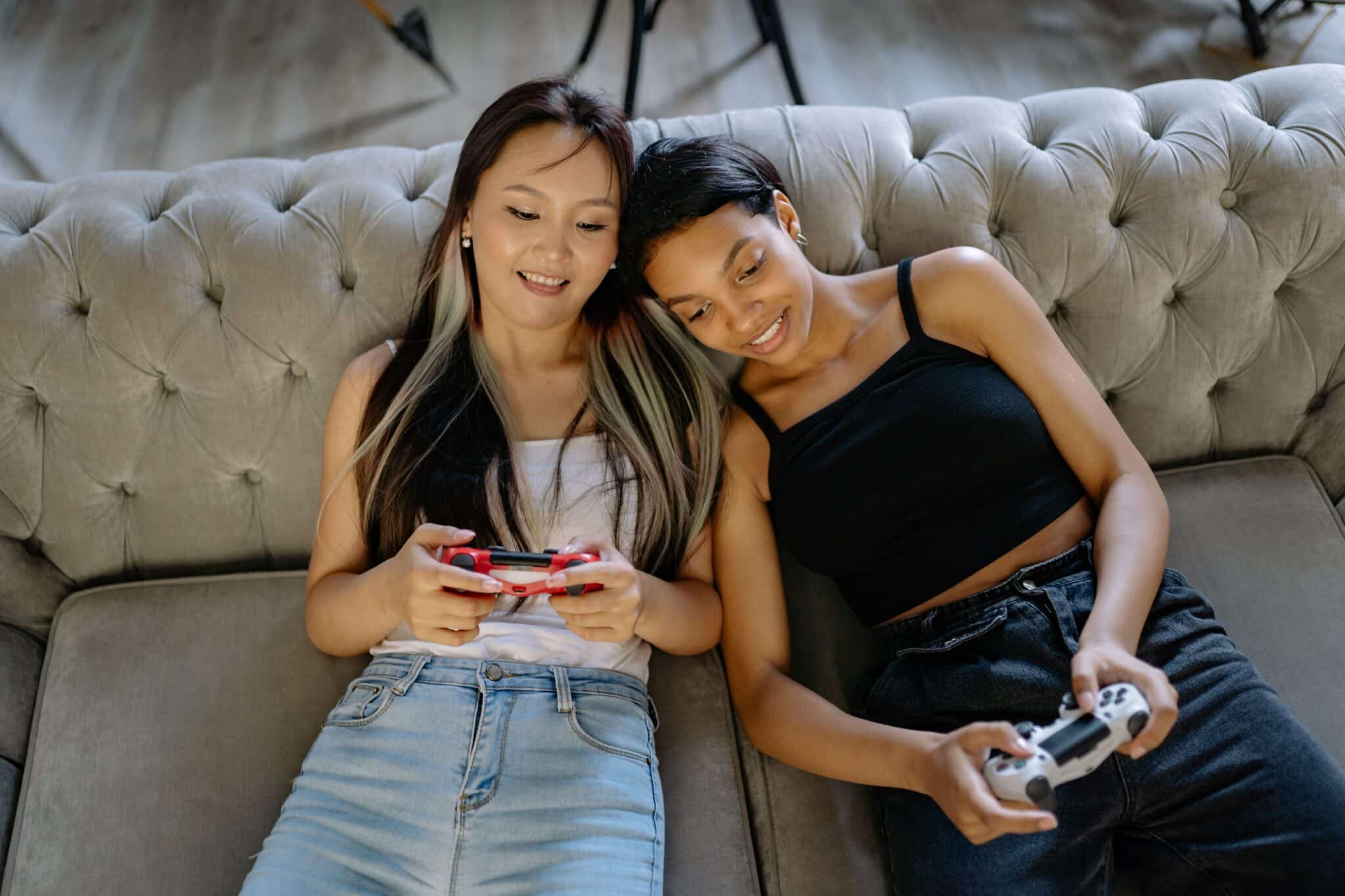 Two women on the couch playing video games