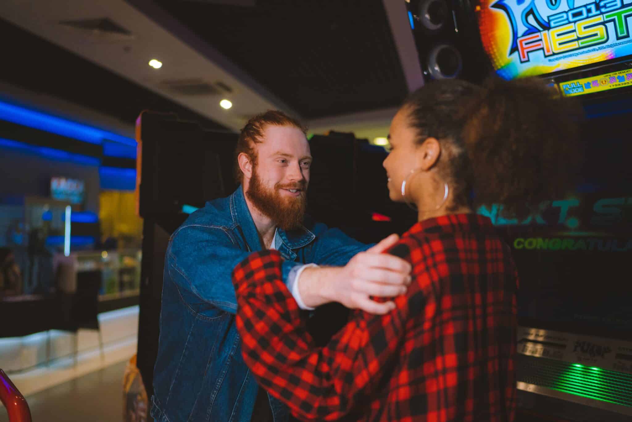 People embracing at an arcade