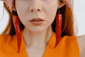 Close up of woman wearing chili pepper earings
