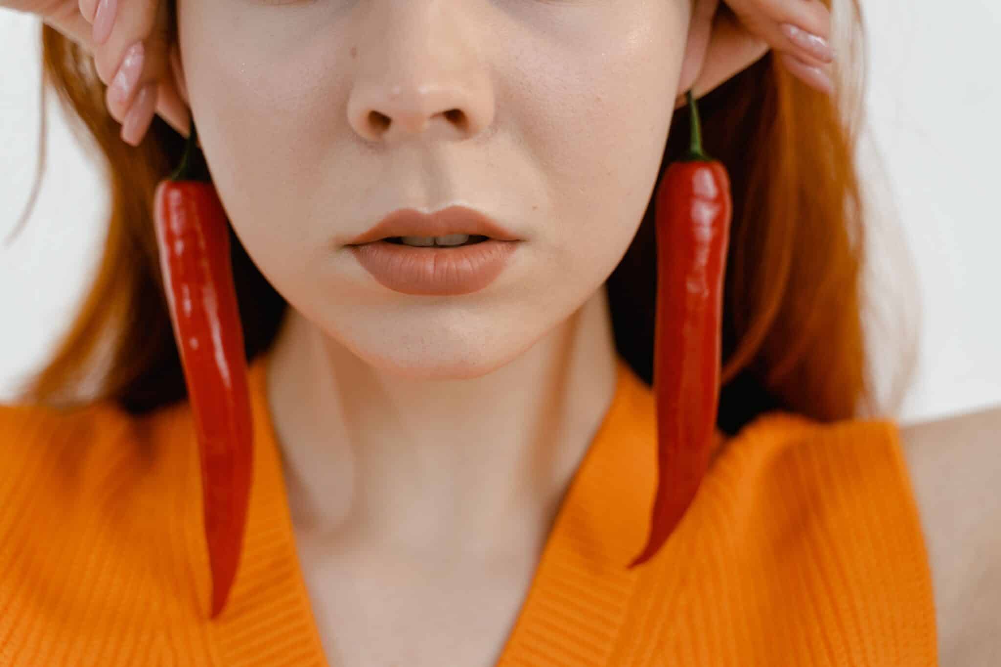 Close up of woman wearing chili pepper earings