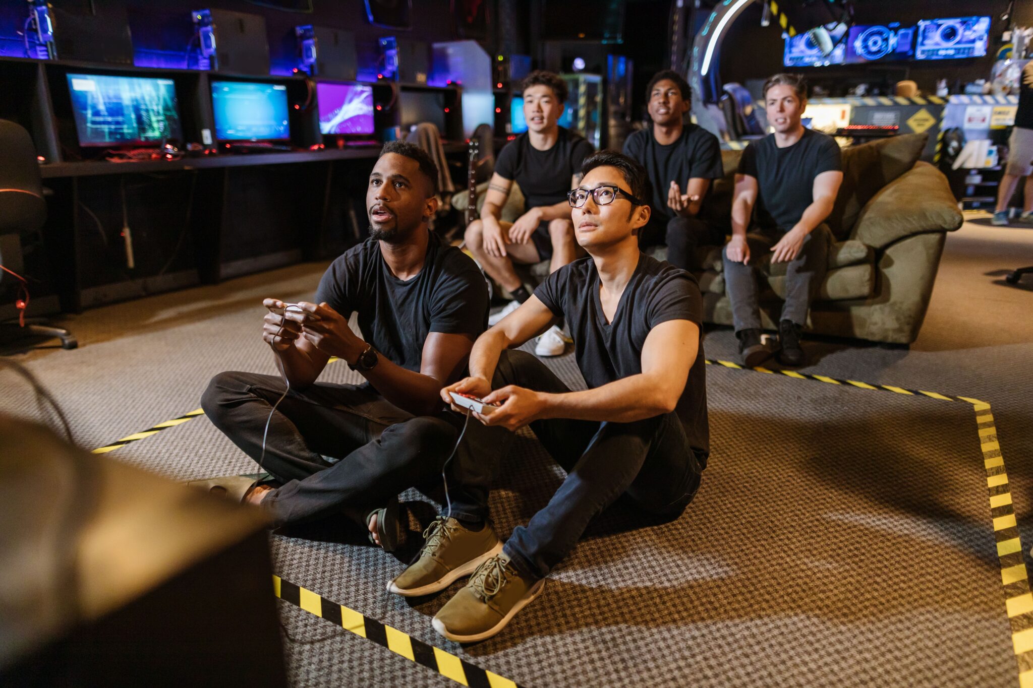 People surrounding a screen playing video games
